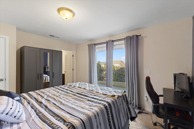 bedroom featuring baseboards and visible vents