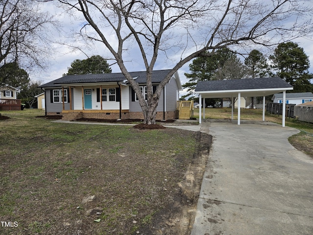 view of front of house featuring crawl space, fence, an attached carport, driveway, and a front lawn