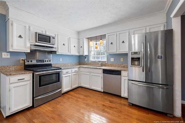 kitchen featuring stainless steel appliances, white cabinets, and a sink