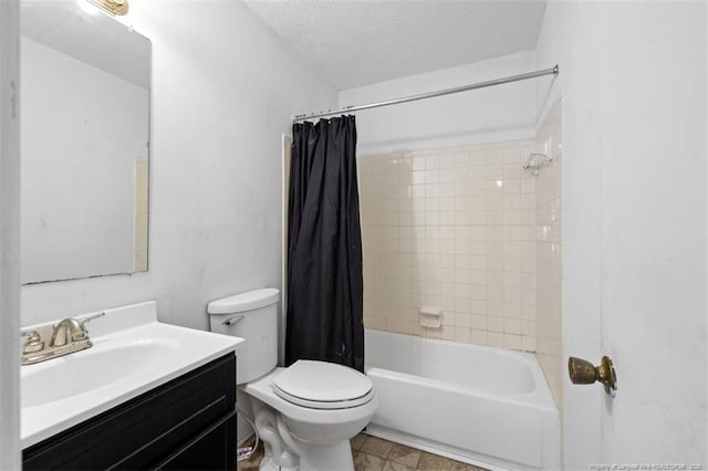 full bath featuring a textured ceiling, shower / tub combo, vanity, and toilet