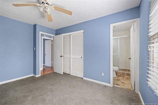 unfurnished bedroom with a textured ceiling, a closet, carpet flooring, and ensuite bathroom