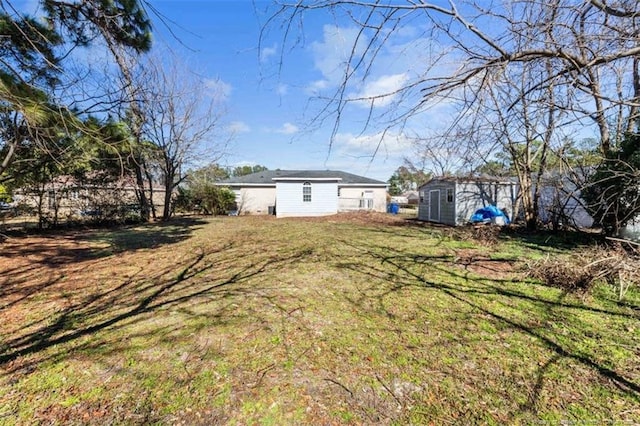 view of yard with an outbuilding and a storage unit