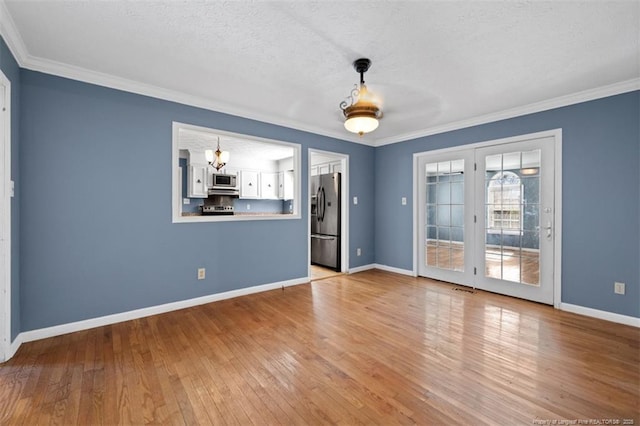 unfurnished room with baseboards, crown molding, and light wood-style floors