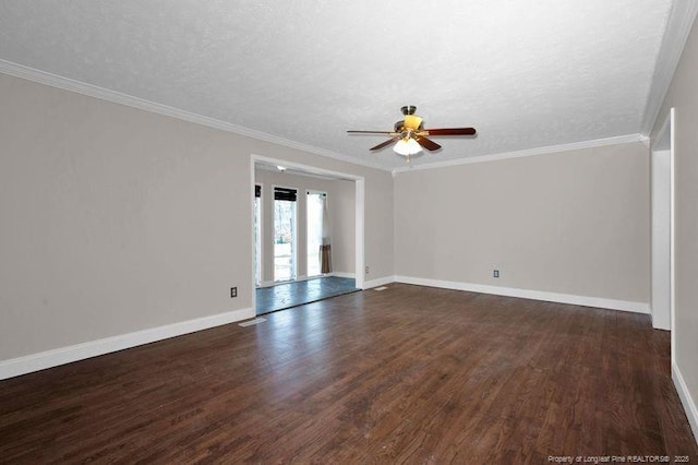 spare room featuring ornamental molding, dark wood-type flooring, and baseboards