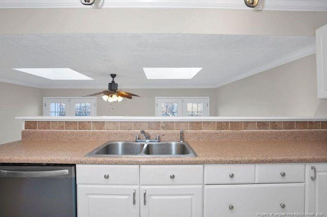 kitchen featuring crown molding, stainless steel dishwasher, white cabinets, a sink, and ceiling fan