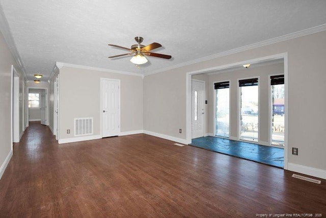 unfurnished living room featuring visible vents, ornamental molding, a textured ceiling, wood finished floors, and baseboards