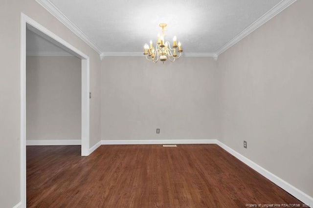 empty room with baseboards, a chandelier, crown molding, and wood finished floors