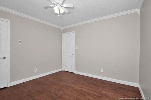 spare room featuring crown molding, wood finished floors, and baseboards