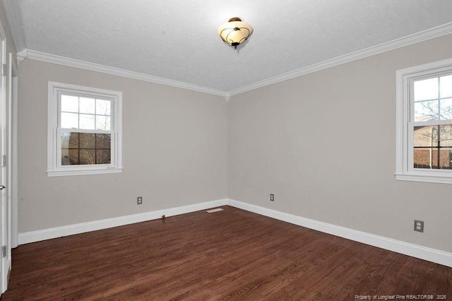 spare room featuring baseboards, dark wood-style flooring, and ornamental molding