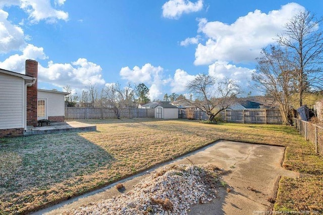 view of yard featuring an outbuilding, a shed, a patio area, and a fenced backyard