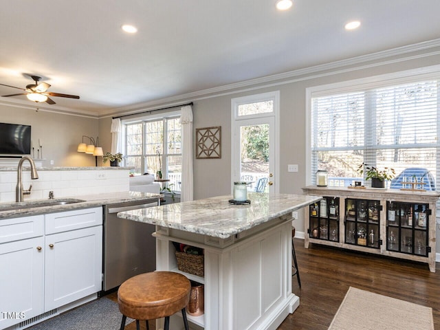 kitchen with a sink, open shelves, dishwasher, and crown molding