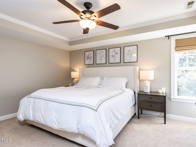 carpeted bedroom with visible vents, ceiling fan, crown molding, and baseboards