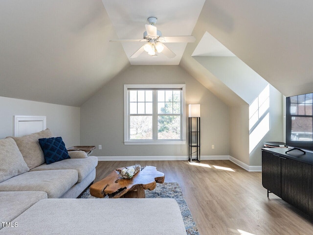 living room featuring a ceiling fan, lofted ceiling, baseboards, and wood finished floors