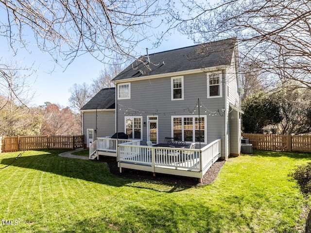 rear view of property featuring a yard, a fenced backyard, central AC, and a wooden deck