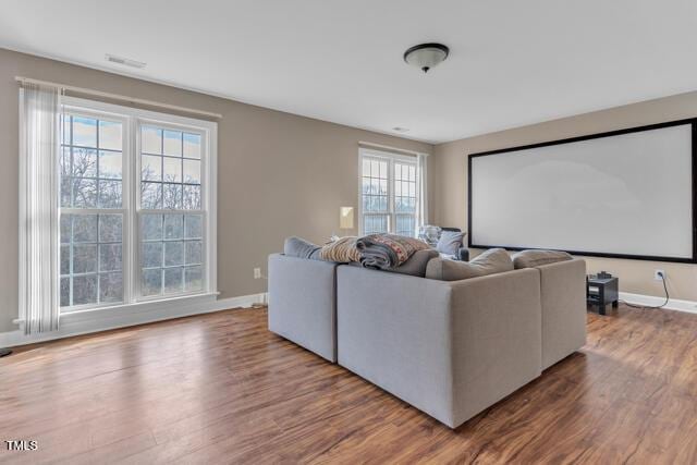 home theater room featuring baseboards and wood finished floors