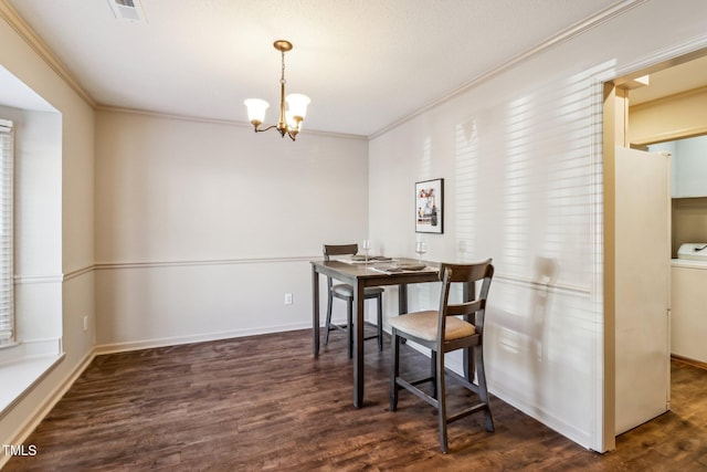 dining area featuring ornamental molding, wood finished floors, visible vents, and a notable chandelier