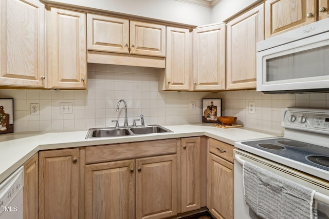 kitchen with white appliances, tasteful backsplash, light countertops, light brown cabinets, and a sink