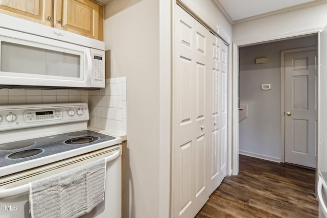 kitchen featuring white appliances, dark wood-type flooring, light countertops, ornamental molding, and decorative backsplash