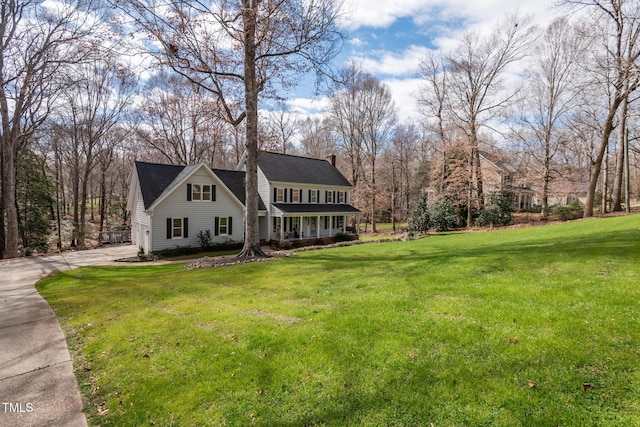 view of front of house with driveway and a front lawn