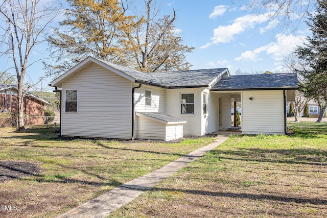 view of front of home featuring a front yard and brick siding