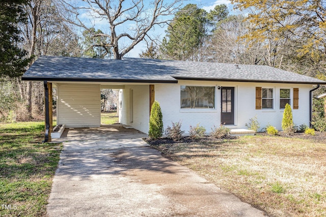 ranch-style home with brick siding, a carport, driveway, and a shingled roof