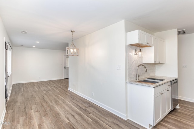 kitchen with visible vents, light wood-style flooring, a sink, light countertops, and dishwasher