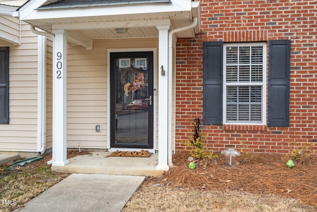 entrance to property with brick siding