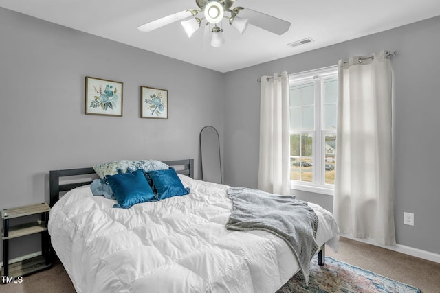 bedroom featuring a ceiling fan, carpet flooring, visible vents, and baseboards