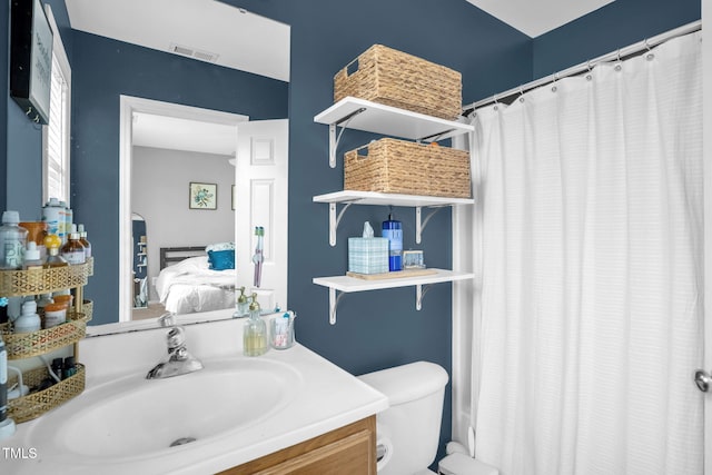 ensuite bathroom featuring toilet, vanity, visible vents, a shower with curtain, and ensuite bath