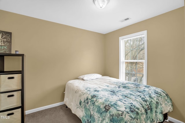 bedroom featuring baseboards, visible vents, and carpet flooring