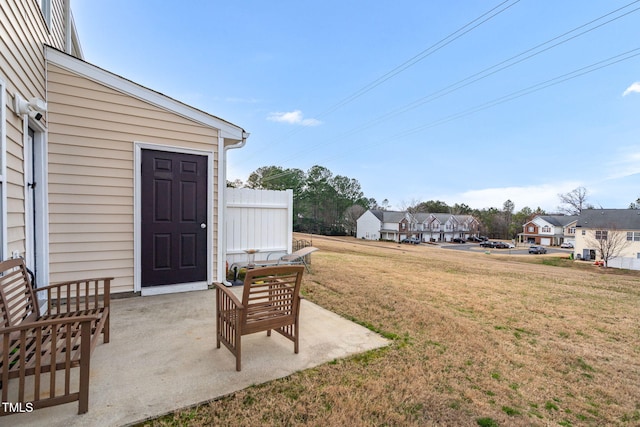 view of yard with a residential view and a patio area