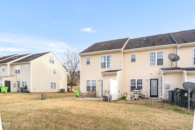 rear view of house featuring central air condition unit, a patio area, and a yard