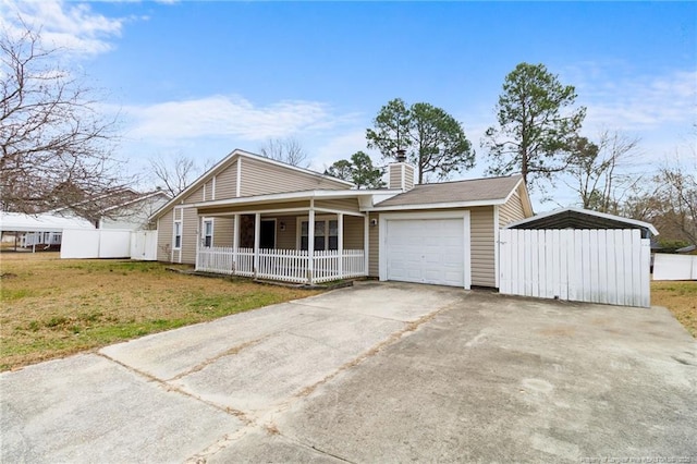 view of front of house with covered porch, fence, a garage, driveway, and a front lawn