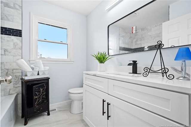 bathroom featuring baseboards, toilet, marble finish floor, a washtub, and vanity