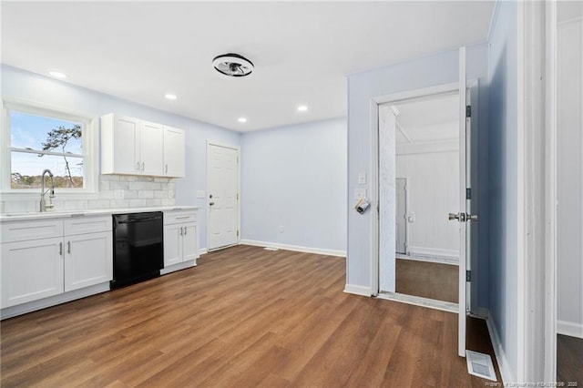 kitchen with visible vents, a sink, dishwasher, and wood finished floors