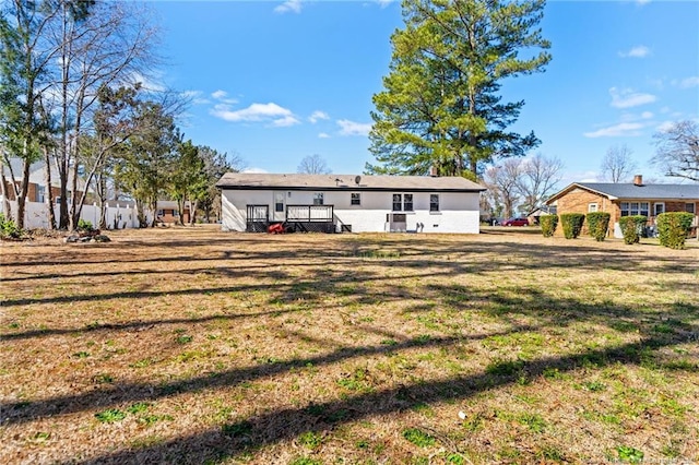 back of house with a lawn