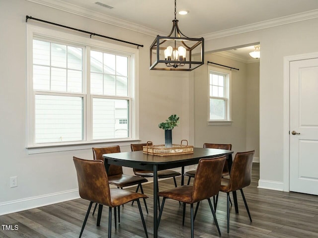 dining room with dark wood-style floors, baseboards, a chandelier, and crown molding