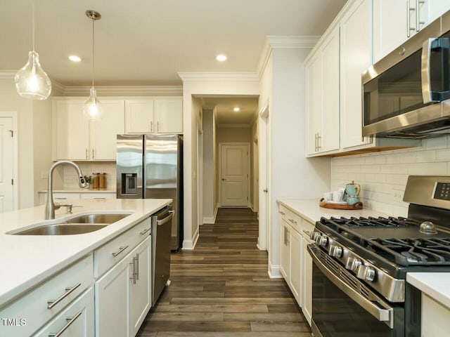 kitchen with a sink, white cabinetry, stainless steel appliances, crown molding, and light countertops