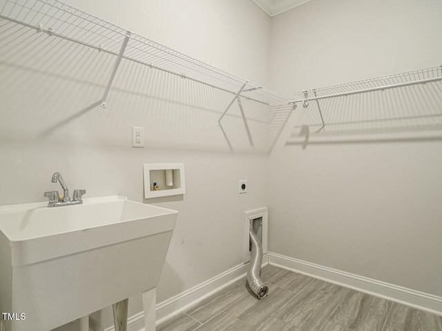 clothes washing area featuring electric dryer hookup, baseboards, washer hookup, and laundry area