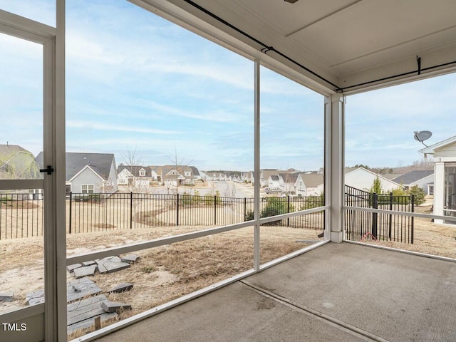 unfurnished sunroom with a residential view