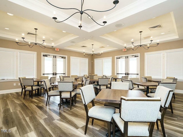 dining room with a notable chandelier and french doors