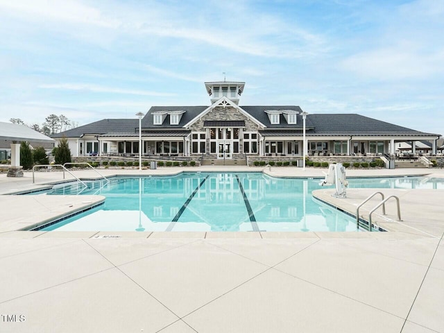 community pool with a patio area