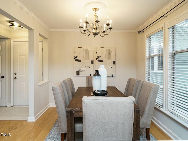 dining room with an inviting chandelier, wood finished floors, and crown molding