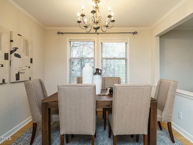 dining area featuring an inviting chandelier, wood finished floors, baseboards, and ornamental molding