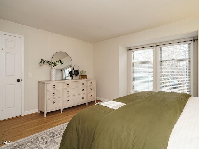 bedroom featuring wood finished floors and baseboards