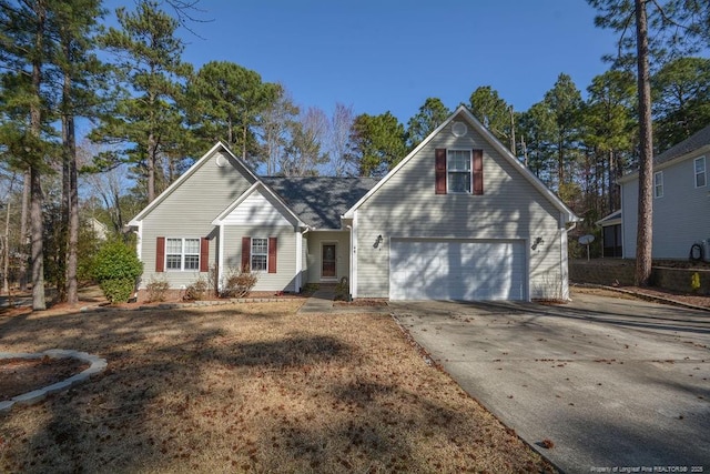 traditional-style house with a garage and concrete driveway