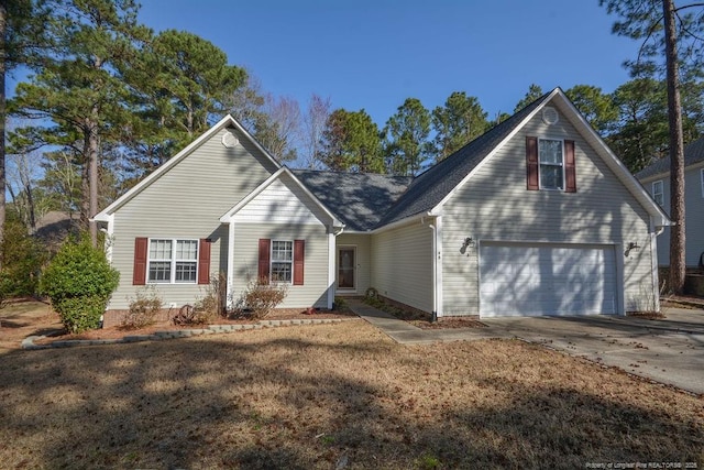 traditional-style home featuring a front lawn and concrete driveway