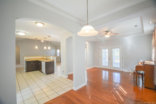 kitchen with arched walkways, french doors, open floor plan, and a wealth of natural light