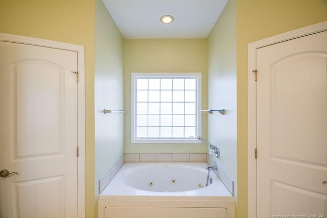 full bathroom featuring a tub with jets