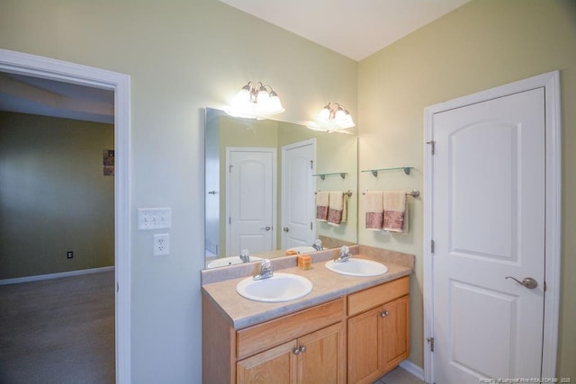 full bath featuring a sink, baseboards, and double vanity